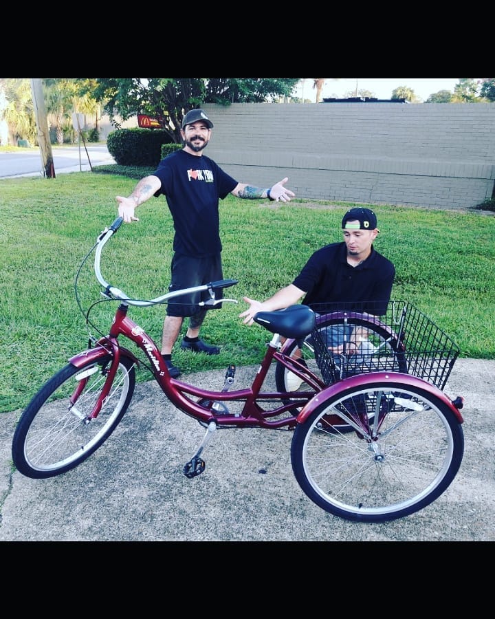 Clean Eatz employees help co-worker with new bike